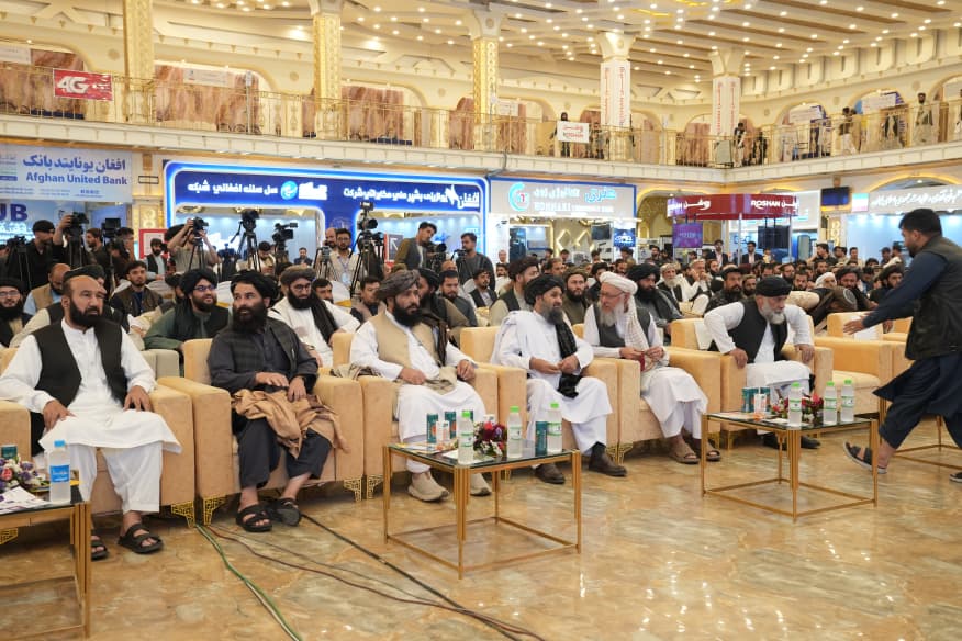 Rows of guests and press cameras at an exhibition opening in Kabul